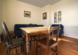 a dining room with a wooden table and chairs at 20 Segontium Terrace in Caernarfon
