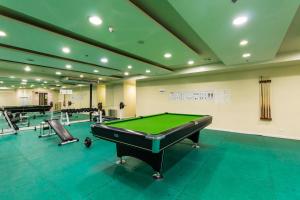 a large room with a pool table and several chairs at JMM Grand Suites in Manila