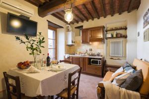 a kitchen with a dining room table and a kitchen with a tableablish at Belvedere in Cortona +38 photos