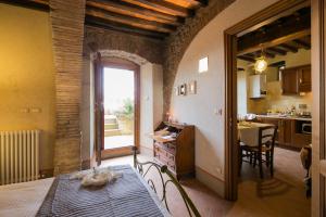 a room with a kitchen and a dining room with a table at Belvedere in Cortona