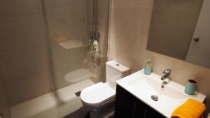 a bathroom with a toilet and a sink and a shower at Cristina Port & Beach - Apartment in Masnou +25 photos