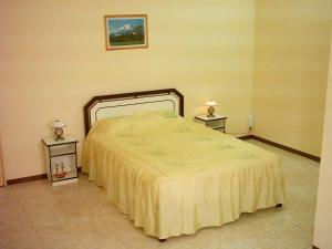 a bedroom with a bed and two night stands at Alpha Villa - Studios without kitchen in Flic-en-Flac