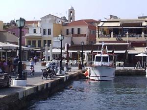 a boat is docked at a dock in the water at Pia Rooms in Chania Town
