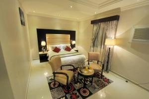 Al Janaderia Suites 7 tesisinde bir odada yatak veya yataklar