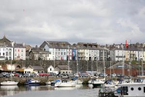 a group of boats docked in a harbor with buildings at 20 Segontium Terrace in Caernarfon
