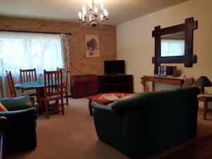 a living room with a couch and a dining room at Crocodile Lodge cc in Midrand