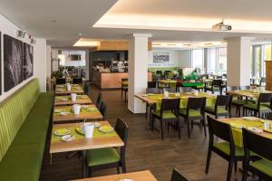 a dining room with wooden tables and chairs at Fischer's Hotel Brauhaus in Mössingen