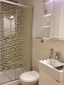 a bathroom with a shower and a toilet and a sink at Mini appartamenti a Catanzaro Lido in Catanzaro Lido +24 photos