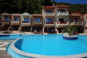 a large swimming pool in front of a building at Blue Green Bay in Panormos Skopelos