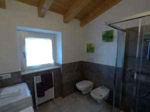 a bathroom with a shower and a toilet and a sink at Ca' Campitol in Torri del Benaco +82 photos