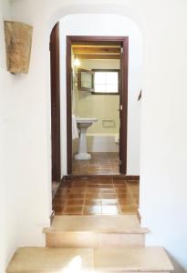 a hallway with a bathroom with a sink and a toilet at Villa Font March in Pollença