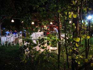 a group of tables and chairs in a park at night at Podere La Branda in Vetralla +165 photos