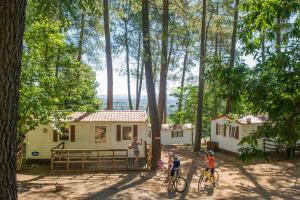 a group of people riding bikes in front of a cabin at VTF La Croix de Vinchannes in Joyeuse