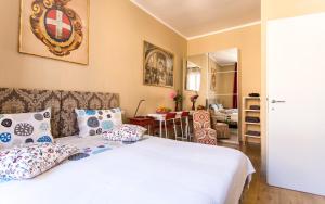 a bedroom with a bed with pillows and a living room at Kiss Inn in Rome