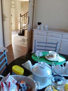 a kitchen with a table with a tea set on it at B&B dal Cardinale in Ozieri
