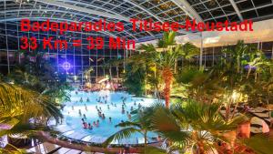a large pool in a building with people in it at Residenz Schauinsland, ganzes Appartement, Sauna in Todtnau