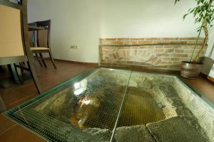 a room with a tub and a fire place in it at Hotel Joseph 1699 in Třebíč