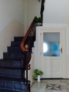 a staircase in a house with a door and a stair case at B&B dal Cardinale in Ozieri