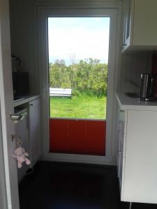 una cucina con porta e vista su una finestra di Luxus Chalet mit Terrasse, sehr ruhig in Kollmar a Kollmar