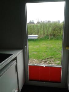 a window in a room with a view of a park at Luxus Chalet mit Terrasse, sehr ruhig in Kollmar in Kollmar