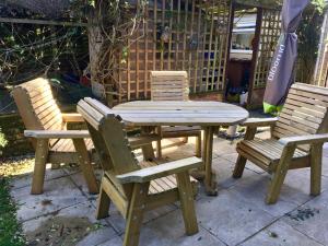 a wooden table and two chairs and a table and chairs at Ashleigh Lodge in Hunstanton