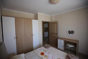 a bedroom with a bed and a mirror at Apartments in RIF 3 in Ravda +46 photos