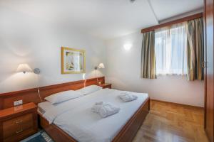 Posteľ alebo postele v izbe v ubytovaní Apartments Punta