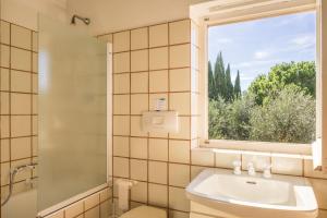 a bathroom with a sink and a window at Case Danesi in Rio nellʼElba