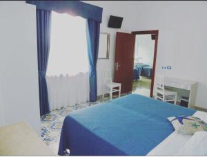 Postel nebo postele na pokoji v ubytování Hotel Britannia