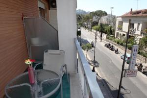 a balcony with a table and a view of a street at Hotel Linda in Sorrento