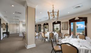 a dining room with tables and chairs and a chandelier at Breezes Resort & Spa All Inclusive, Bahamas in Nassau
