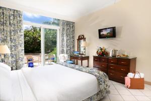 a bedroom with a white bed and a window at Breezes Resort & Spa All Inclusive, Bahamas in Nassau