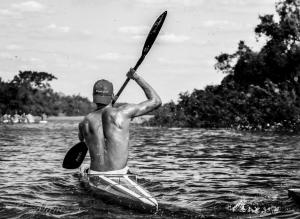 a man is in a kayak on the water at Gran Texier Hotel Casino in Concepción del Uruguay