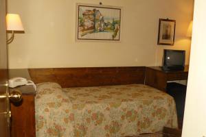 Postel nebo postele na pokoji v ubytování Hotel La Rocca
