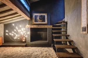 a living room with a fireplace and a ladder at Zona Pedonale - RoughLuxe Home in Arezzo