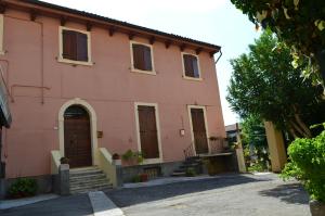 a pink house with stairs and a door at Veronauptoyou Apartments in Verona