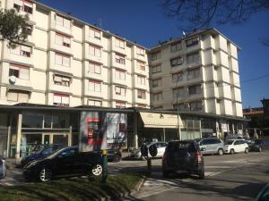 a large building with cars parked in front of it at Europa Red Apartment in Favaro Veneto