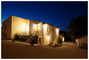 a large white building with stairs and lights on it at Agriturismo Rosso di Sera in Cugnoli