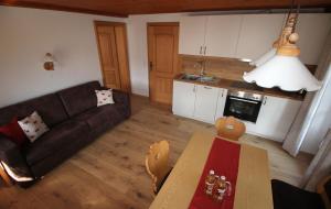 a living room with a couch and a table at Ferienwohnung Schifterhof in Ruhpolding +5 photos