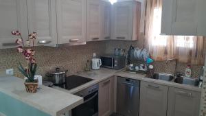 a kitchen with white cabinets and a counter top at Villa Danae in Gaios