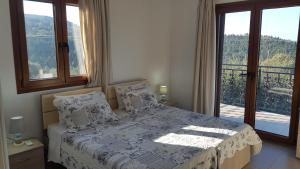 a bedroom with a bed and a large window at Villa Danae in Gaios