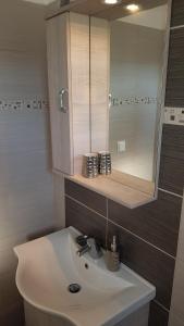 a bathroom with a sink and a mirror at Villa Danae in Gaios +41 photos