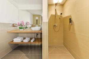 a bathroom with a shower and a sink at Hotel Haunstetter Hof Augsburg in Augsburg