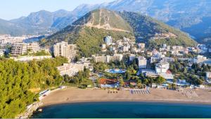 an aerial view of a beach in front of a mountain at Iberostar Bellevue All Inclusive in Budva