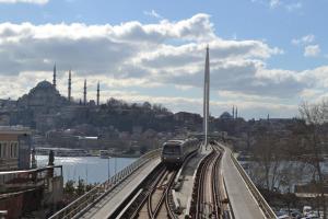a train on a train track near a river at Peradise Hotel in Istanbul
