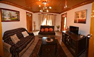 a living room with a couch and a table at Casa Ferreira in Góis