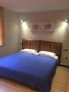 ein Schlafzimmer mit einem blauen Bett mit zwei Kissen in der Unterkunft First line Apartment in Benidorm