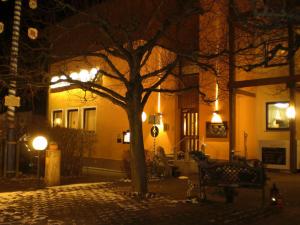 a bench in front of a building at night at Gasthof Fröhlich in Langenbruck