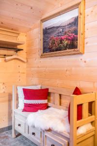 a log cabin with a bed and a picture on the wall at Knusperhauschen Sonnegg in Flachau