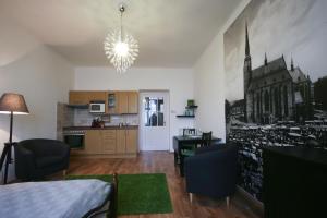 a living room with a kitchen and a dining room at Apartmán Mrakodrap in Plzeň